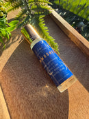 Kitty Karma Studio: Moonwashed perfume roller lying on wooden board