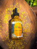 Kitty Karma Studio: Osmanthus oil bottle on wooden board with petals