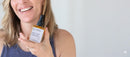 Elodie's Naturals: Woman holding orange serum bottle