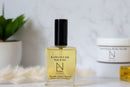 Elodie's Naturals: Body oil bottle with black cap on a shelf