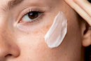 Elodie's Naturals: White lotion being applied to cheek