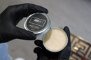 The Good Sh*t: Gloved hands holding open beard balm tin