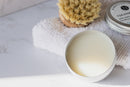 Elodie's Naturals: Open cleansing balm tin on towel