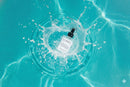 Elodie's Naturals: Serum bottle floating in turquoise water